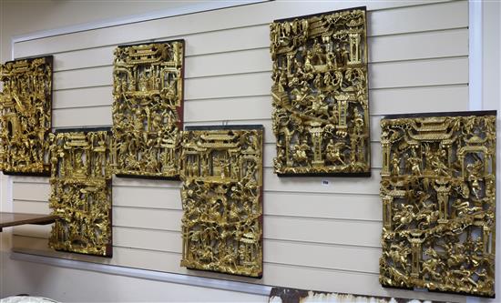 Six Chinese carved giltwood panels of soldiers amid pavilions